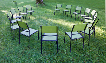 Stühle stehen in einem Park im Kreis