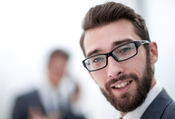 close up.smiling businessman in the office background