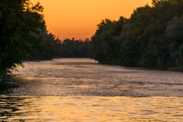 Image of river reflecting colors during sunset