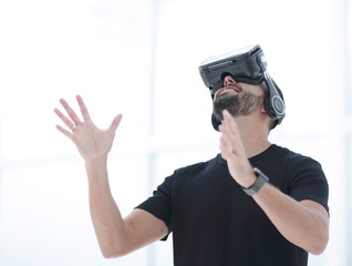 portrait of an amazed guy using a virtual reality headset isolated