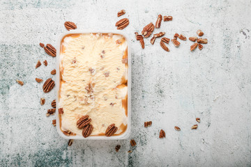 ice cream with ground nuts on white concrete table
