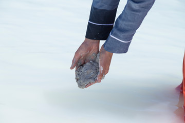 the woman hold Chyle or Argil or clay or sand in the hand at the Salda lake from Turkey.