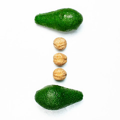 Ripe fresh avocado, walnuts isolated on white background with shadow top view Flat lay copy space....