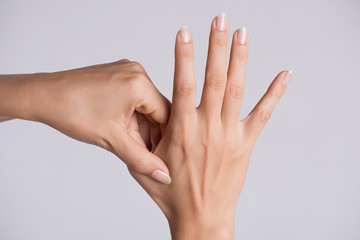 Healthcare and medical concept. Woman massaging her painful hand.