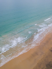 Aerial view of empty blue beach shore.