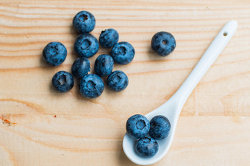 Many fresh bluederry on the wooden table close up