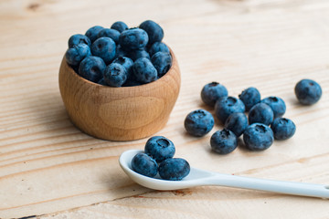 Many fresh bluederry on the wooden table close up