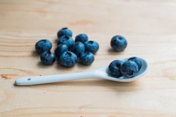 Many fresh bluederry on the wooden table close up