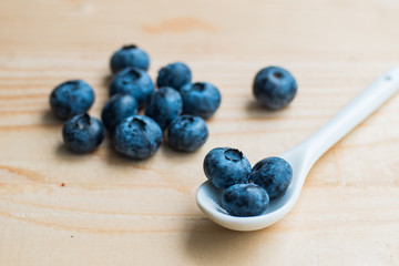 Many fresh bluederry on the wooden table close up