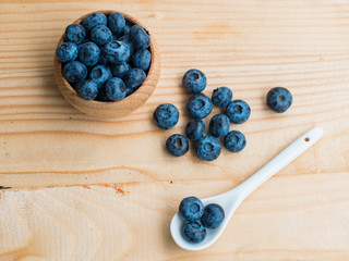 Many fresh bluederry on the wooden table close up