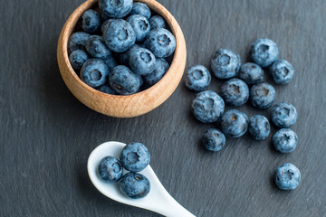 Many fresh bluederrys on the blacktable close up