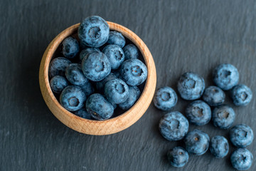 Many fresh bluederrys on the blacktable close up