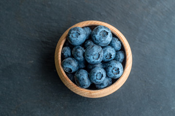 Many fresh bluederrys on the blacktable close up