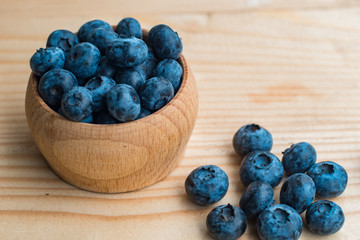 Many fresh bluederry on the wooden table close up