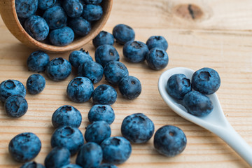 Many fresh bluederry on the wooden table close up