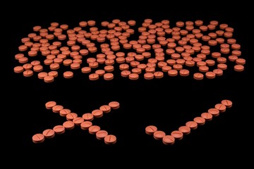 Orange colour round pills on black background with selective focus. Pills that look like ecstasy.