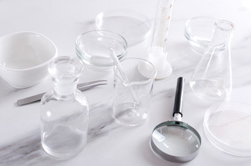 Different kinds of medical glassware, professional equipments on the laboratory testing table