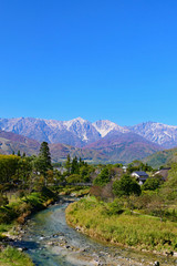 清流、姫川と大出の吊り橋。北アルプス、白馬三山を望む。白馬　長野　日本。10月下旬。