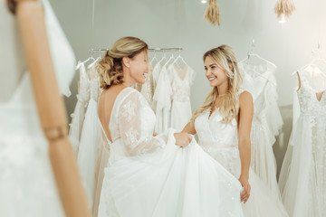 Naklejka premium Two beautiful women meeting in a wedding salon.