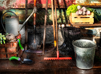 Simple garden tools on the background of the old shabby barn wall