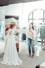 Gorgeous bride dancing in a wedding shop.
