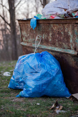 garbage in the nature, cleaning the environment in the spring on the river from the rubbish a woman...