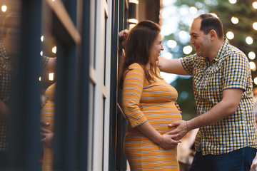 man holding belly of pregnant wife