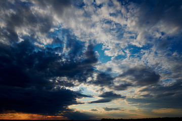 Beautiful sunset - dark sky with clouds and sunlight