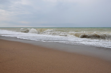 Fototapeta na wymiar Stormy sea with high waves and beach