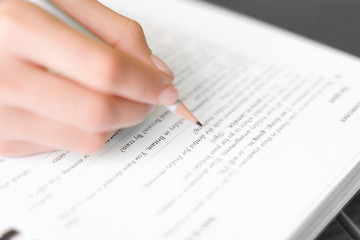 Hand writing with pencil exercises in study book or document for work isolated on white empty...