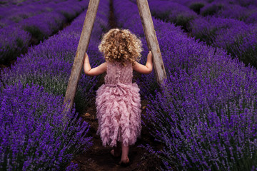 little girl in pink dress lavender blondy curls