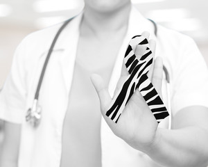 Carcinoid Cancer Awareness rare disease ribbon zebra stripe pattern on doctor hand