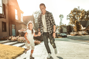 Obraz premium Stylish young father in checkered shirt and jeans playing with little girl