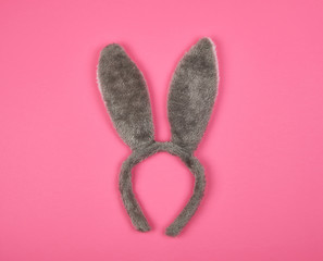 Fur headdress of a hare with ears on a pink background