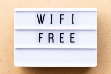 Lightbox with word wifi free on wood background