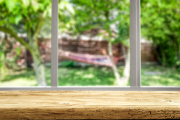 Wooden desk of free space and summer window background 