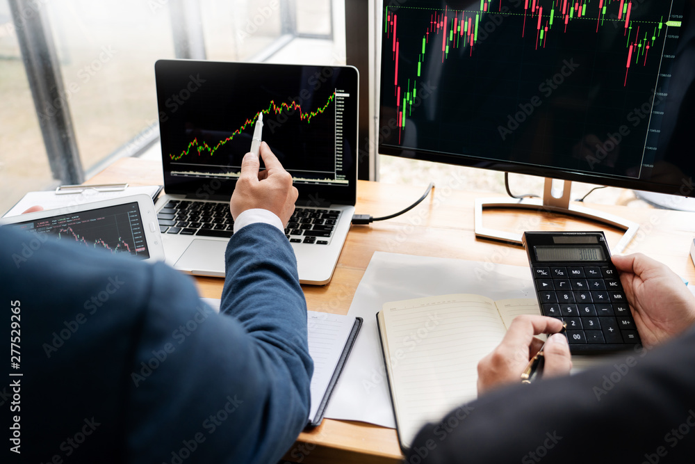 Poster team of stockbrokers discussing with display screens analyzing data, graphs and reports of stock mar