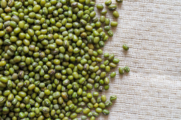 Mung bean seeds have long been used as food for human beings, green beans, seeds that are placed in a white plate, placed on a table with tears and tablecloths....