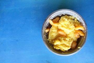 corn porridge with apricots on a blue table