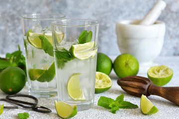 Mojito is a traditional summer cold drink with lime, mint and alcohol. Summer drink.