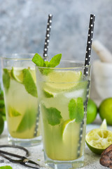 Mojito is a traditional summer cold drink with lime, mint and alcohol. Summer drink.