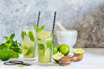 Mojito is a traditional summer cold drink with lime, mint and alcohol. Summer drink.