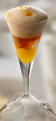bebida dulce  con guindas en  copa de cristal. sweet drink with cherries in glass goblet.