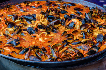 Spanish paella is being cooked in a large pan at a street market in Melbourne Australia