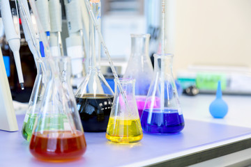 Chemical analysis, pharmacology and laboratory concept. Flasks with colored liquid reagents in a science laboratory.