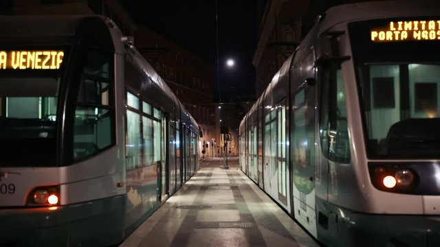 Street scene with modern tram in city center in Rome. Public Transport Tram System in Italy. City dwellers and tourists who use public transport at night.