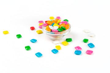 Bowl of rounded square unchewed multicolored bubble gum pieces