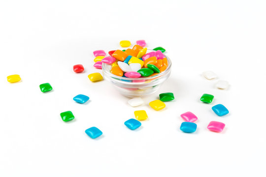 Bowl of rounded square unchewed multicolored bubble gum pieces