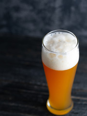 Close-up of a glass of wheat beer on a dark stone background