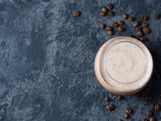 Chocolate coffee smoothie in a glass on a concrete table with copyspace